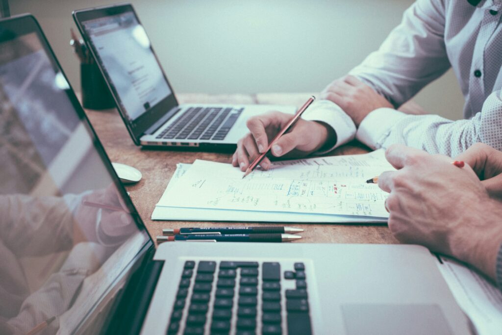 Two individuals reviewing business or financial documents.